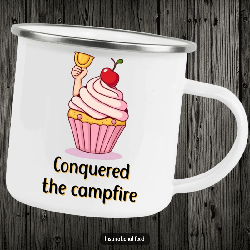 Smiling cupcake triumphantly holding a cherry on a sturdy enamel camping mug.