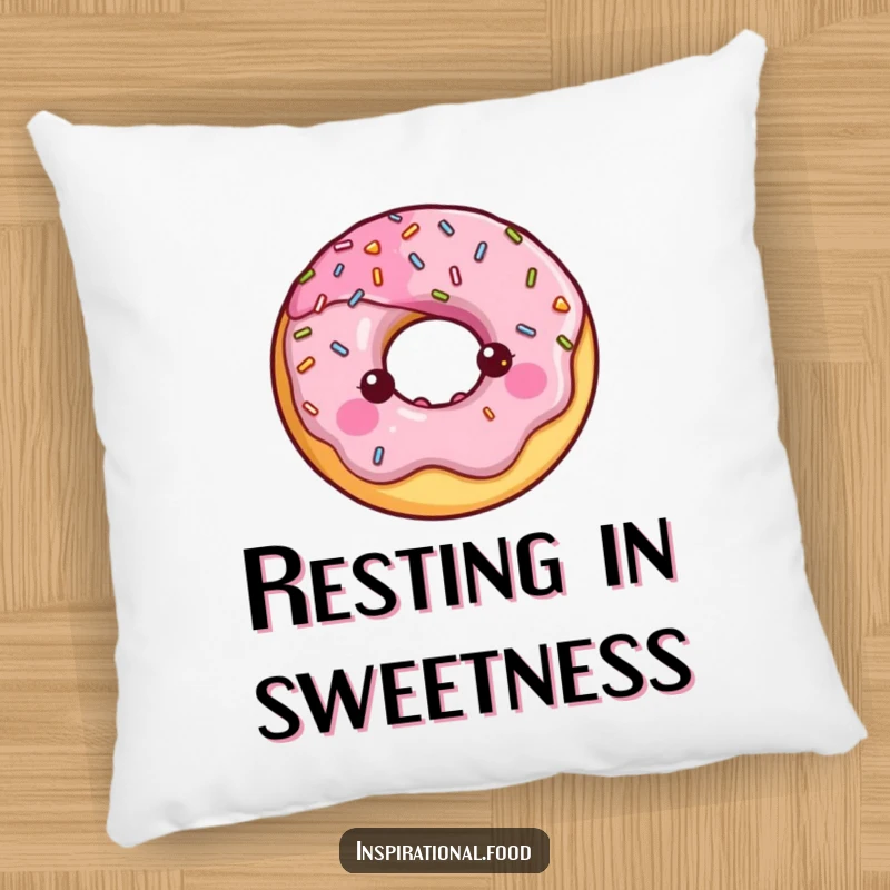 Happy donut character with a halo of shiny sprinkles on a plush pillow.