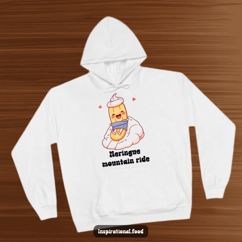Funny hoodie depicting a baguette character gleefully descending a towering meringue mountain, perfect for food lovers and humor seekers.